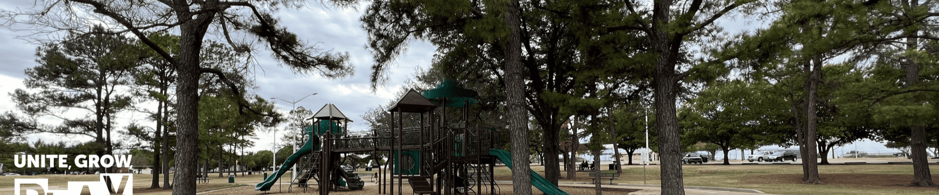 Photo of playground with parks logo in the left side corner