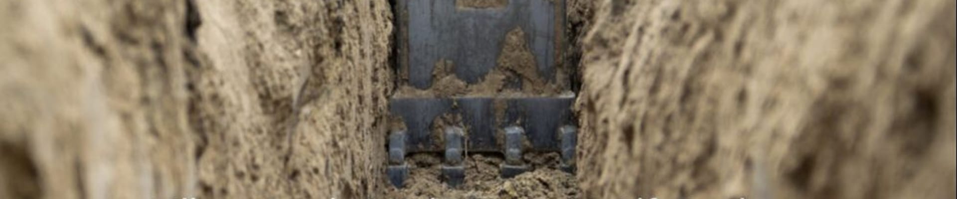 Hole of dirt with text saying "Milam Creek Gravity Sewer & Lift Station"