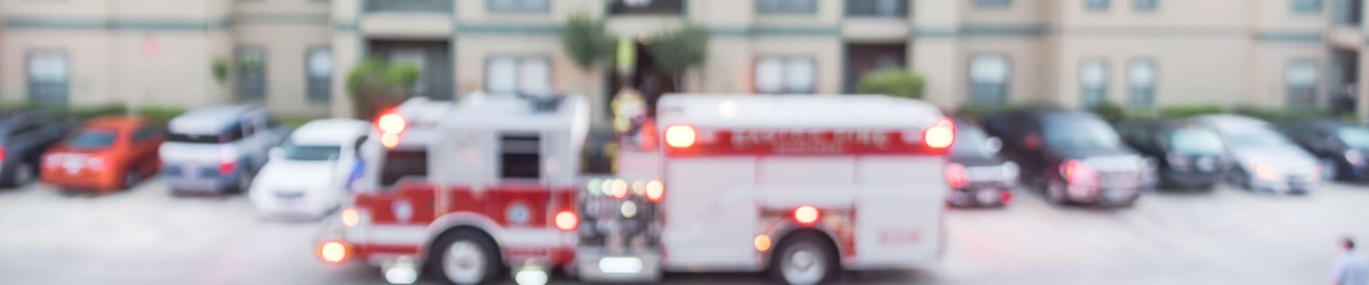 Blurred photo Fire truck in front of apartment building