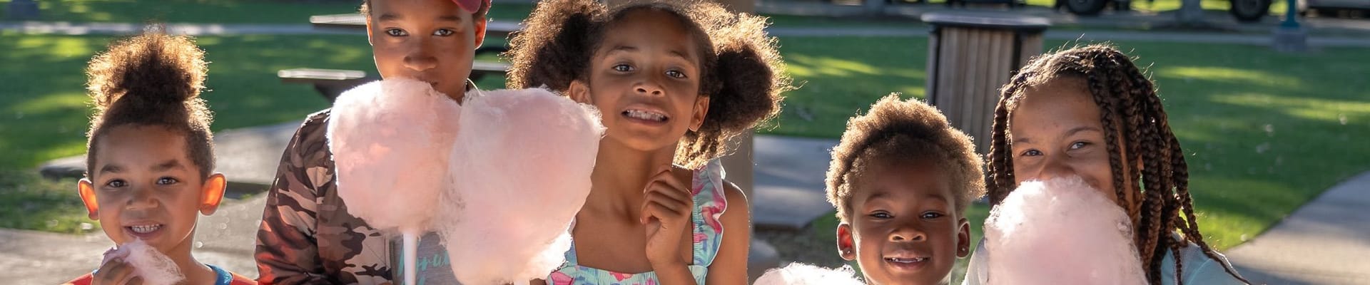 A group of children eating cotton candy.