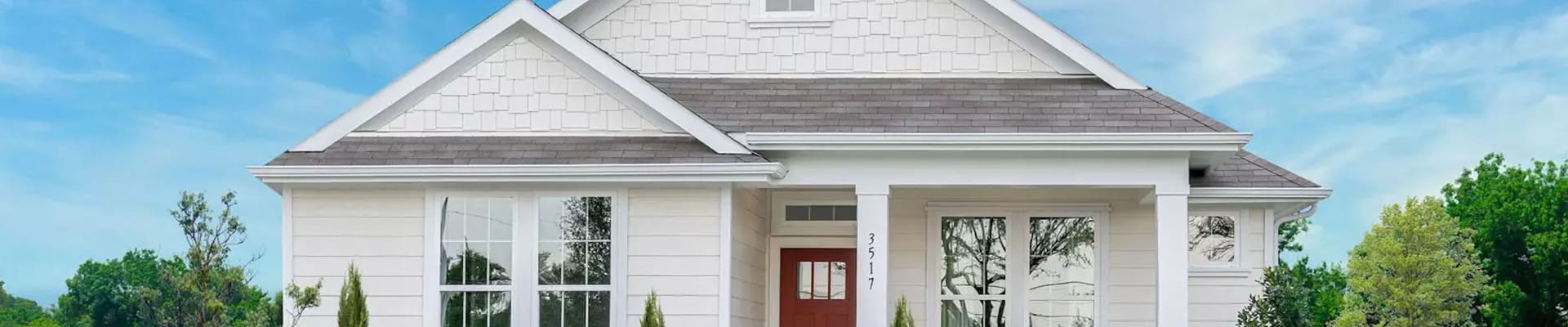 A white ADU with a lawn