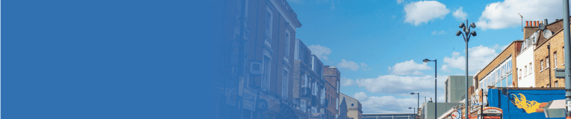 Photo of Deptford High Street with public art, shop fronts, and pedestrians in view