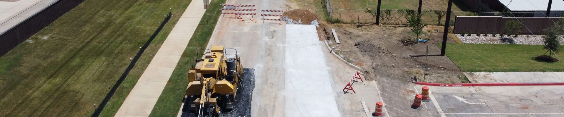 Construction on Riney Road with a yellow construction truck and orange cones