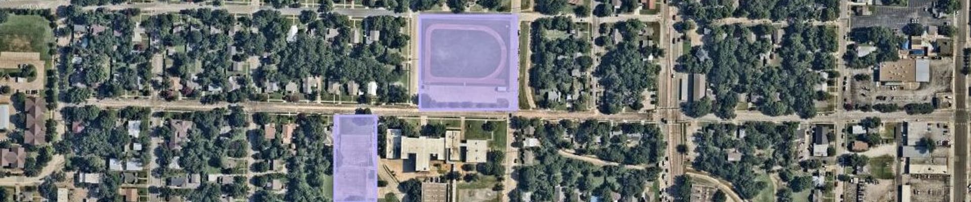 A north-oriented aerial satellite image of central Denton, focused on the Old Calhoun Middle School campus showing the new Congress street park areas in lavender squares to the North and West of the old campus.
