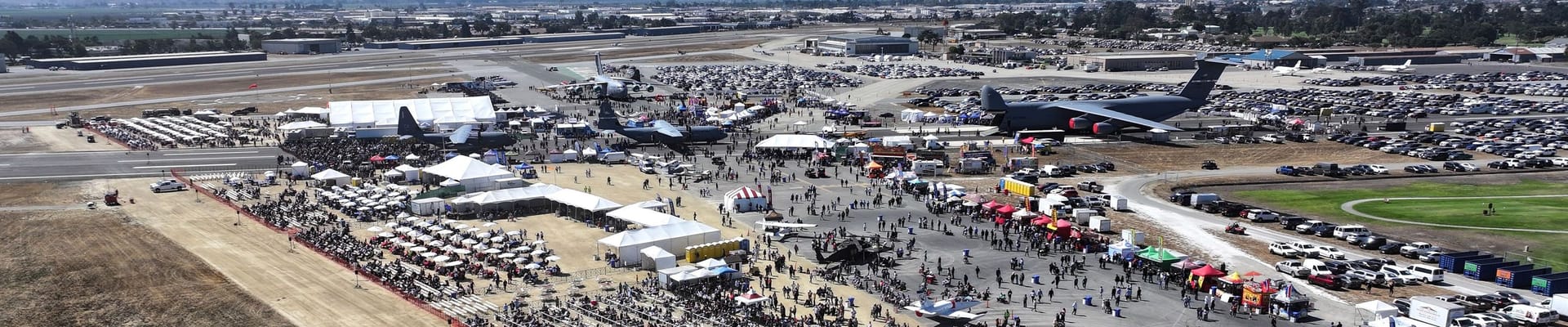Large planes and crowds at the airport during the airshow