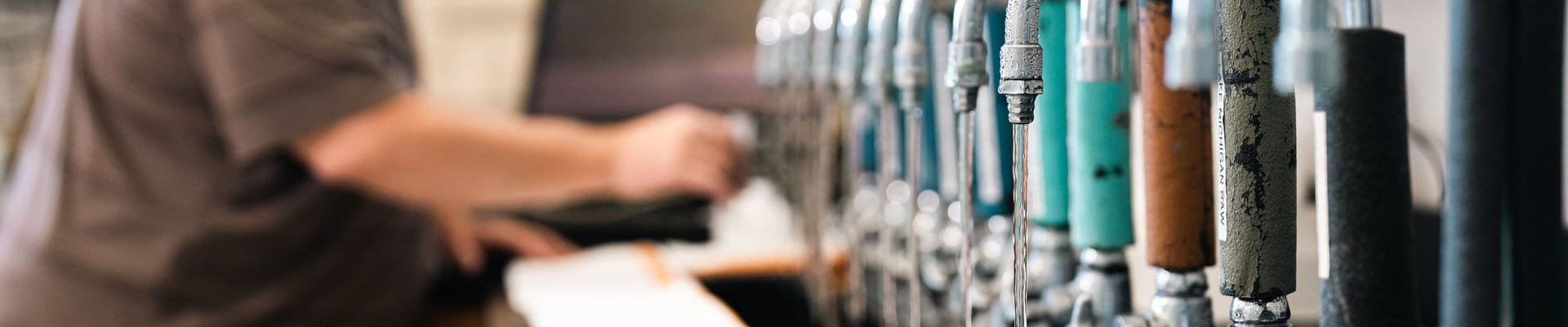 Muskegon water filtration staff testing water faucets