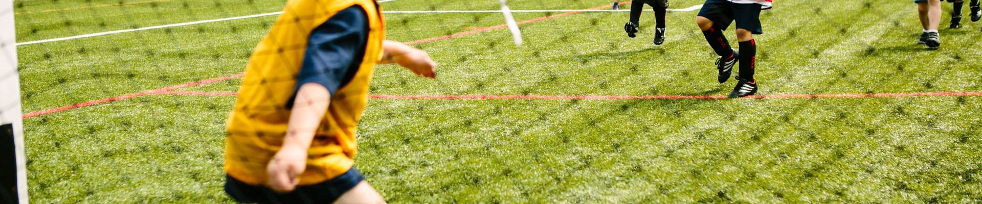 Young children playing soccer