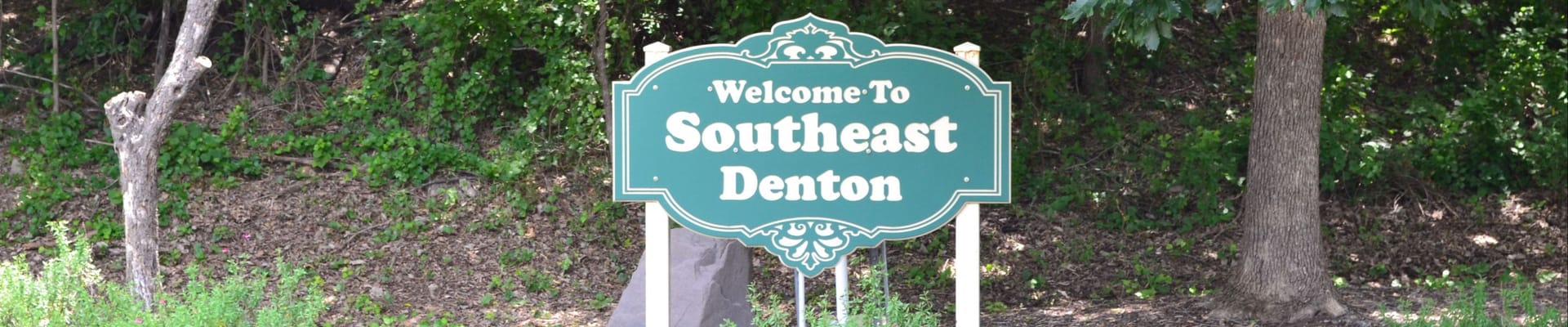 Welcome to Southeast Denton Sign in front of greenery landscape