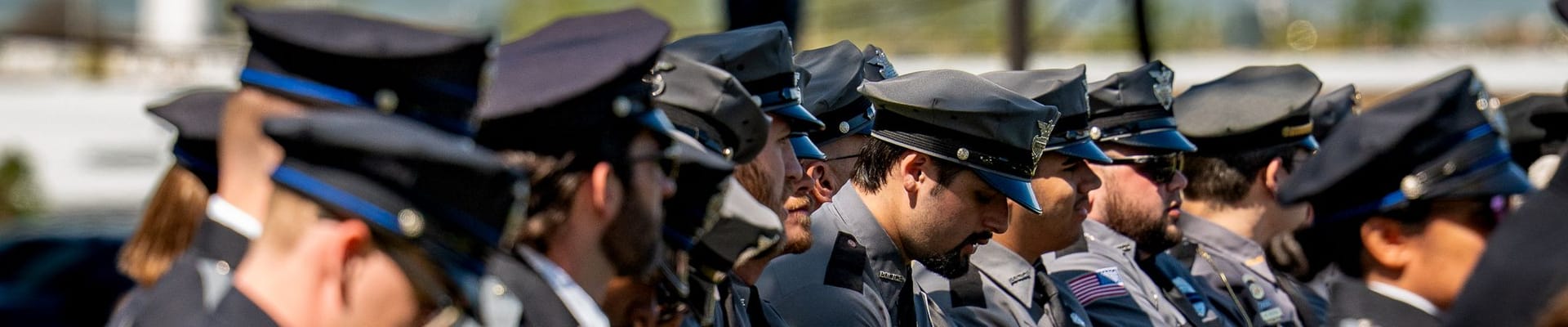 Police Officers sitting in a row during a ceremony.