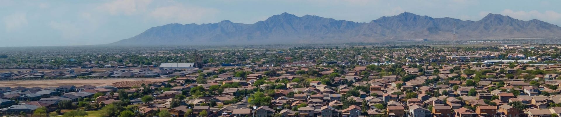 ariel view of houses and Estrella Mountains