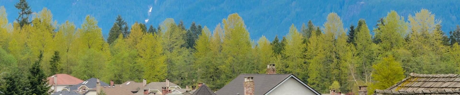 District of North Vancouver apartment buildings with mountains in the background