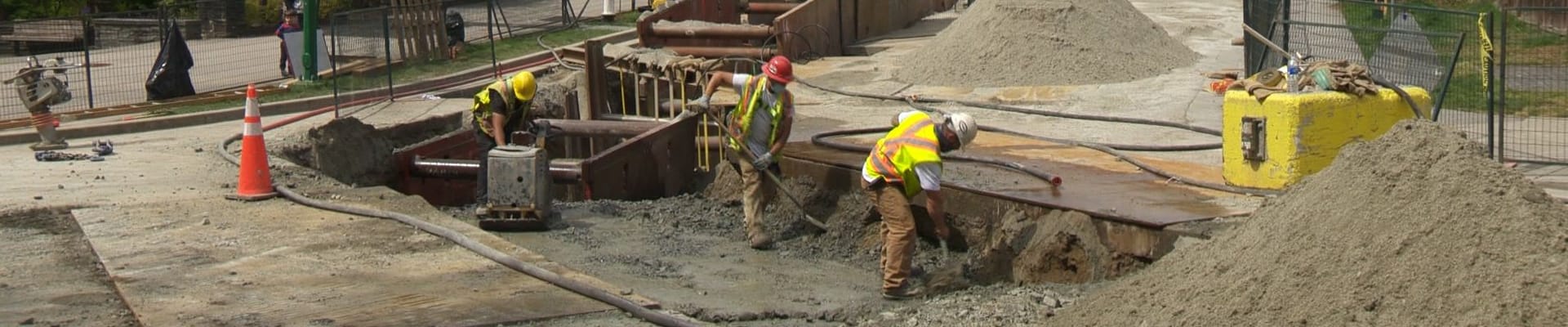 Construction workers excavating the ground