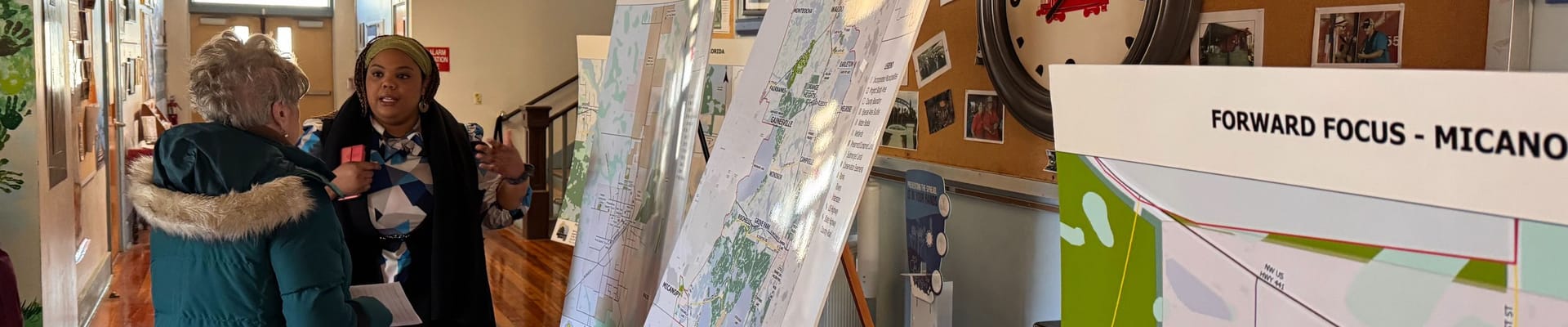 Alachua County residents talk in front of maps for the Forward Focus project.