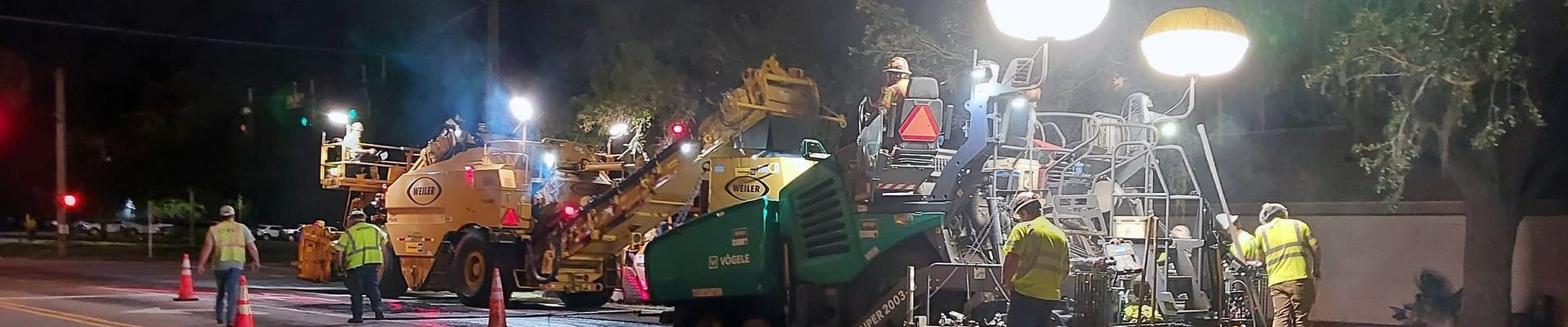 County employees working on a roadway at night