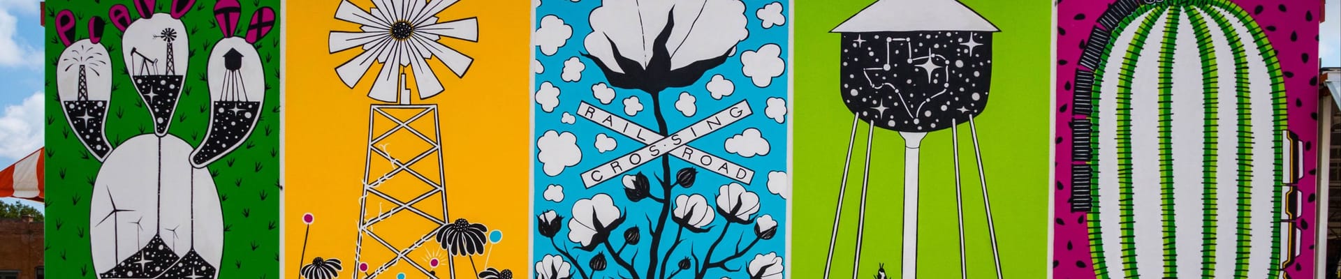 Two large bronze statues of longhorns and one statue of a cowboy riding a horse