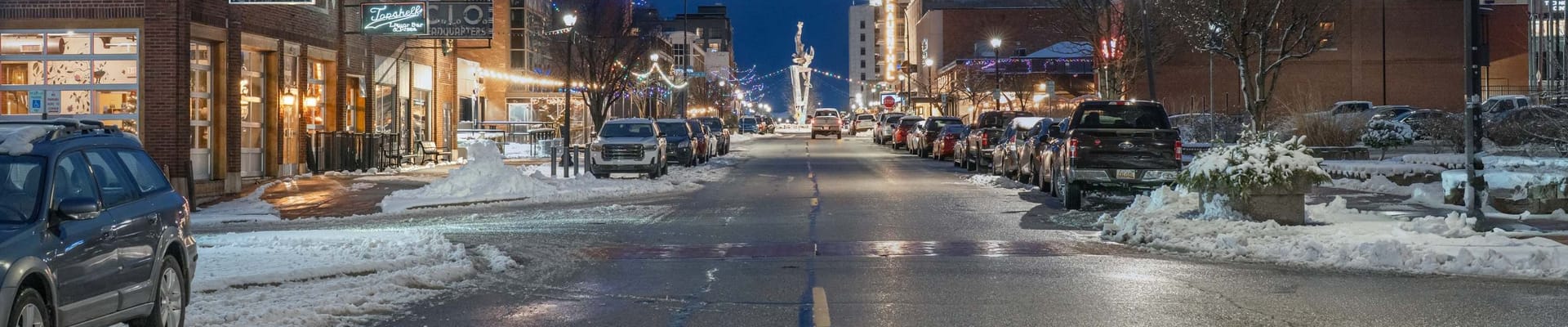 winter street with cars and businesses