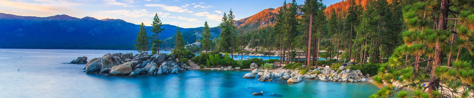 Lake Tahoe and Nevada Landscape - featuring trees, water, rocks, mountains, and clear sky