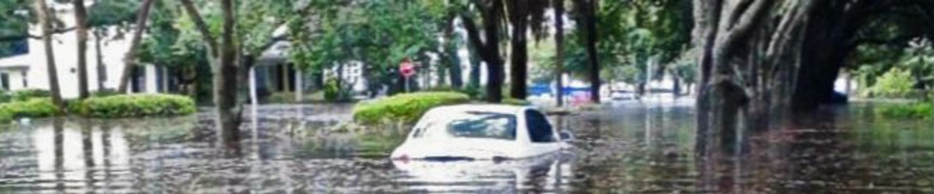 Photo of car in flooded Parkland neighborhood street