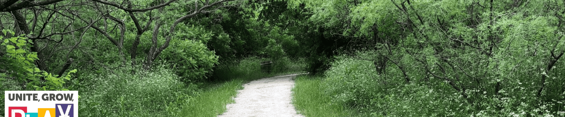 Photo of trail landscaping with parks logo in left side bottom corner