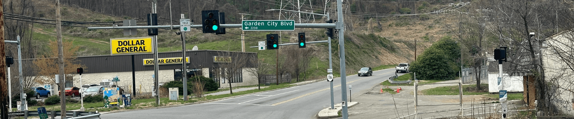 photo of road at an intersection of Garden City Boulevard. Dollar General store is on the right side of the road.