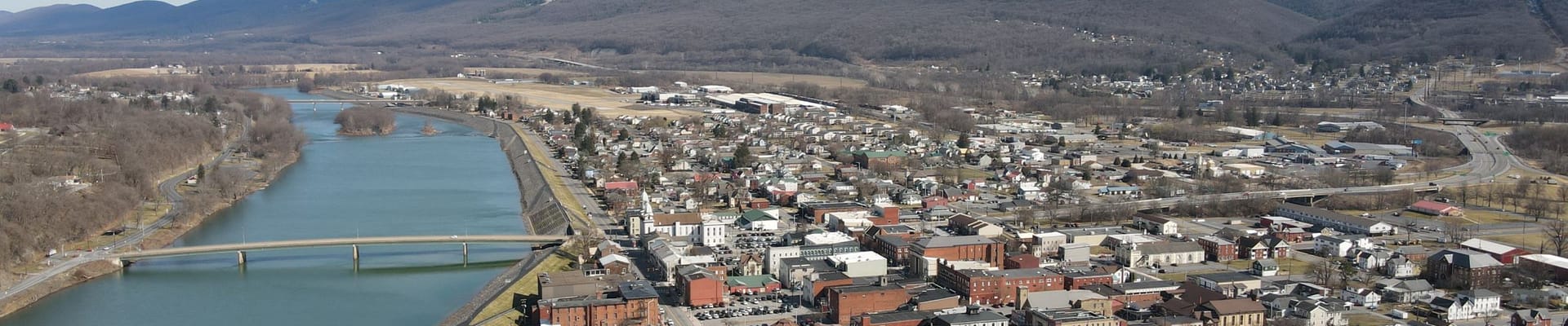 Aerial photo above Lock Haven, Pennsylvania showing parts of the city, levee, and West Branch Susquehanna River.