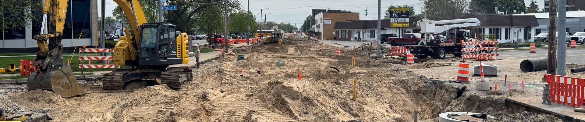 Reconstruction of road with dirt, crane and cones