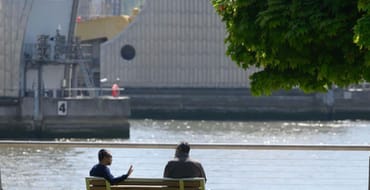 people sitting by thames barrier