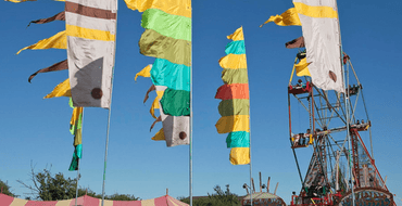 Image of colourful flags and a ferris wheel
