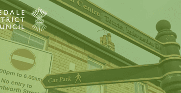 An image of black and gold signage in Malton directing pedestrians to one of the car parks