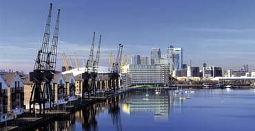 Image of Royal Victoria Dock showing modern buildings and historic cranes