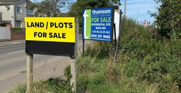Boards advertising land for sale in Kilwinning