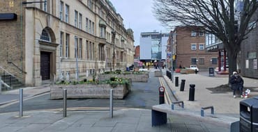 Image showing the Town Hall and Oakfield Road. The foreground includes paving, seating, bollards and a raised planting bed, while the background shows surrounding buildings