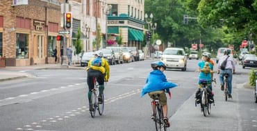 A group of cyclists ride toward Main Street on 6th Street in downtown Vancouver.