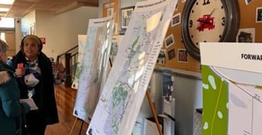 Alachua County residents talk in front of maps for the Forward Focus project.