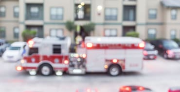 blurred fire truck in front of apartments