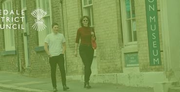 Two people walking through Malton