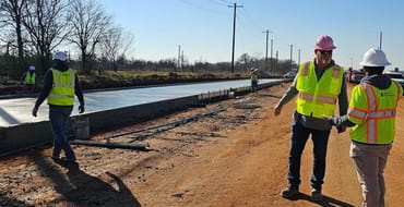 Construction on street with concrete being laid