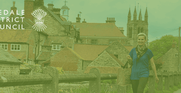 An image of two men in smart casual work attire walking through a park to work and the Ryedale District Council logo