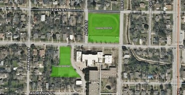 An aerial image of the two distinct park parcels, the track and field to the north of the old Calhoun Middle School Campus, and the tennis court area to the west of the campus. Each parcel is shaded in a transparent lavender. 