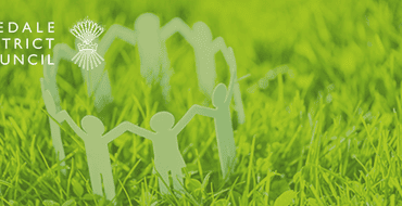 Image showing grass with paper people in a circle and the Ryedale District Council logo