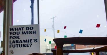 Colorful interior scene featuring a sign that reads, “What do you wish for Laramie’s future?”