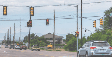 Car driving on the road through traffic signals. 