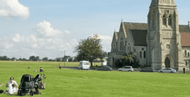 Image of grass meadows and church