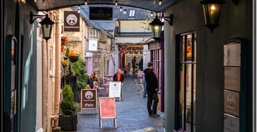 Image of a cobbled street with shops 