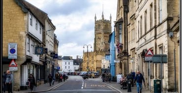 Image of a street with The Parish Church of St John Baptist in the background