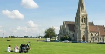Image of grass meadows and church