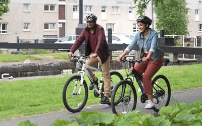 Two people riding a bike