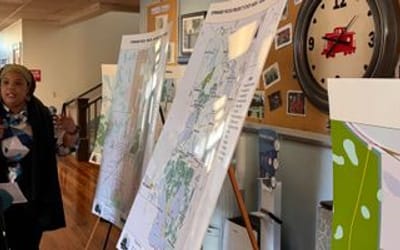 Alachua County residents talk in front of maps for the Forward Focus project.