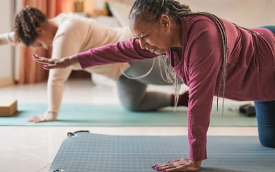 two women doing yoga