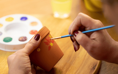 someone painting a pot